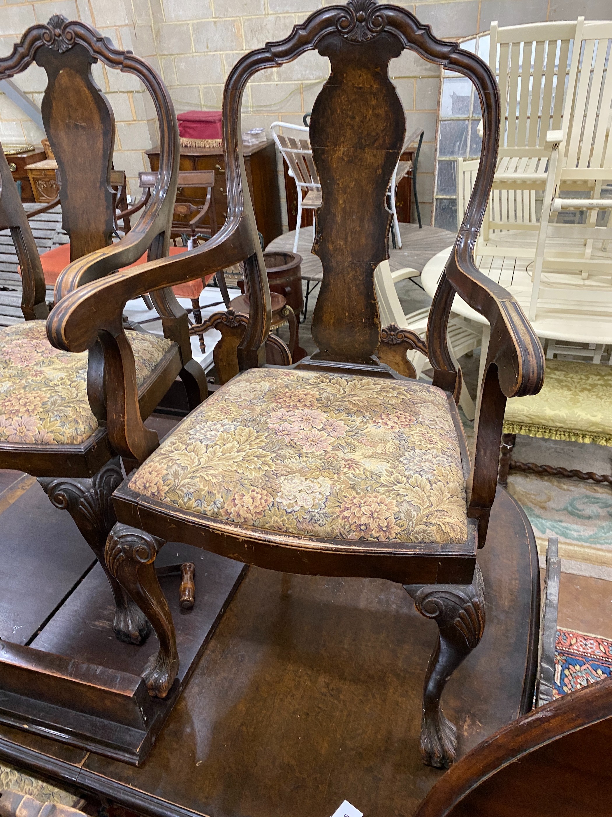 A Queen Anne revival burr walnut dining room suite, comprising extending dining table 208cm extended, two spare leaves, width 106cm, height 74cm and six dining chairs, two with arms